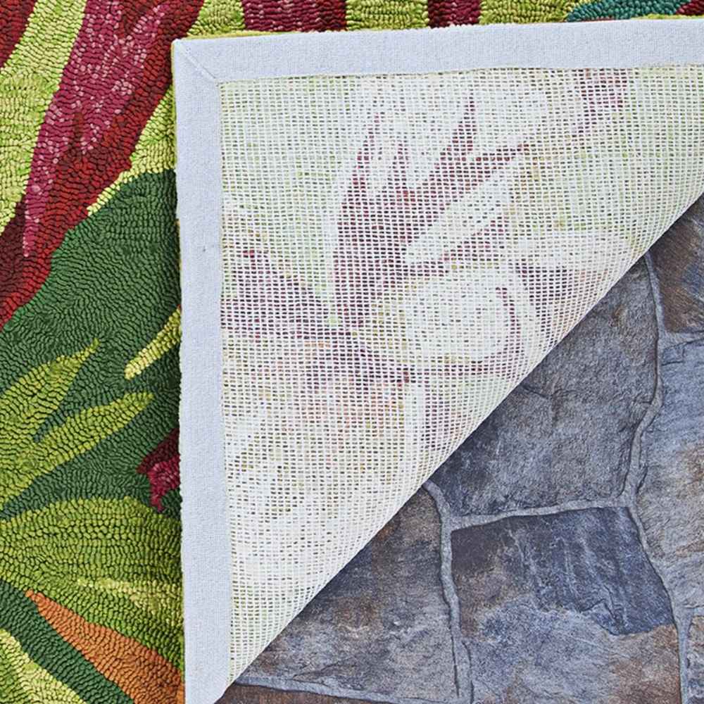 The underside of the Couristan Covington Indoor/Outdoor Rug - Painted Fern/Fern-Red is shown with a white woven backing, offering insight into its sturdy build