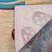 The underside of the Couristan Covington Indoor/Outdoor Rug - Sandals/Sand-Multi reveals its mesh backing and the reverse view of the flip-flop design