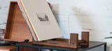 This Crosley Record Storage Display Stand - Natural keeps records upright with a wooden base and clear acrylic panels