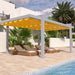 This close-up poolside shot captures the vivid yellow fabric of the Structureworks Balance Trex Pergola stretching over relaxing wicker lounge chairs
