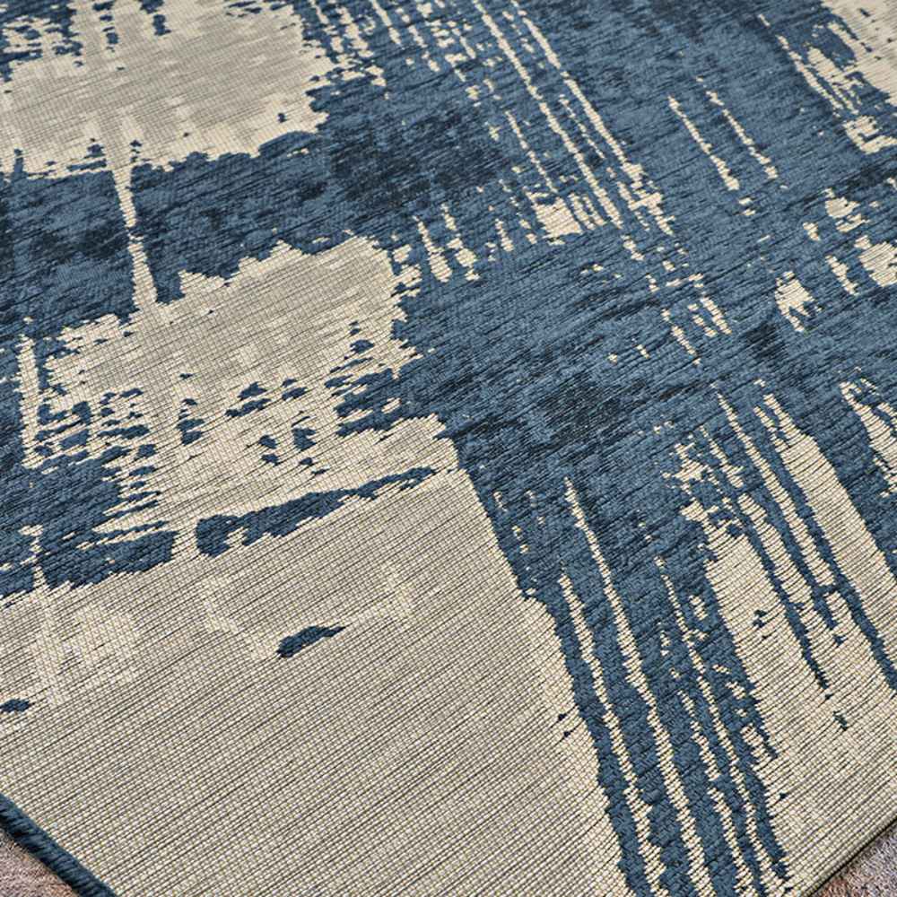 This angled view reveals the Couristan Castille Indoor/Outdoor Rug - Canvas/Orion’s brushstroke-inspired design and subtle texture