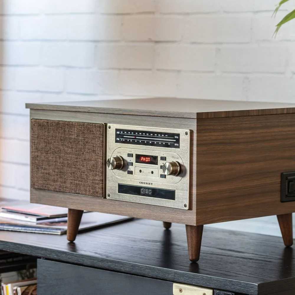 This classic wooden music player, the Crosley Serenade 8-In-1 Record Player - Walnut, showcases a closed lid, front speaker grille, and control panel