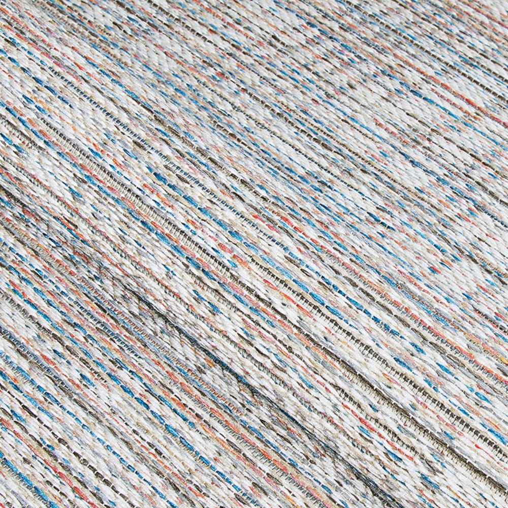 This close-up captures the intricate woven texture of the Couristan Cape Indoor/Outdoor Rug - Falmouth/Ivory-Coral with visible threads in ivory, coral, blue, and other colors