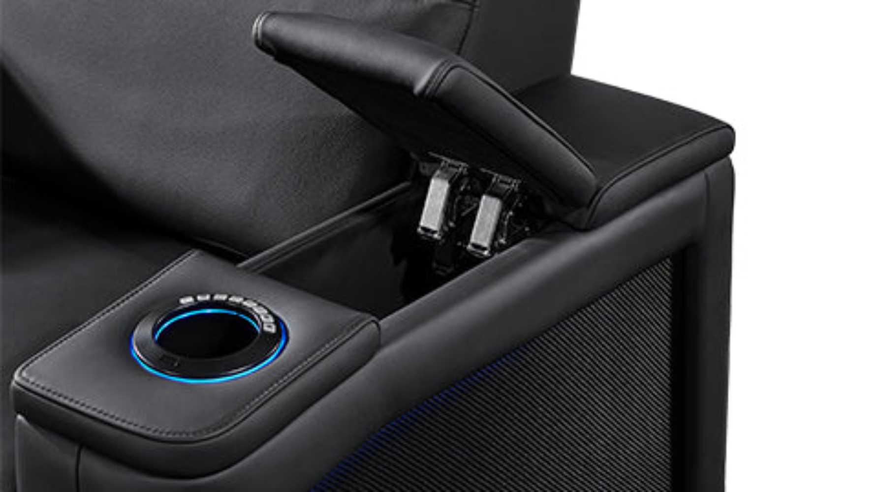 This image focuses on the Valencia Monza Single Pillow Top Carbon Fiber Home Theater Seating's hidden armrest storage