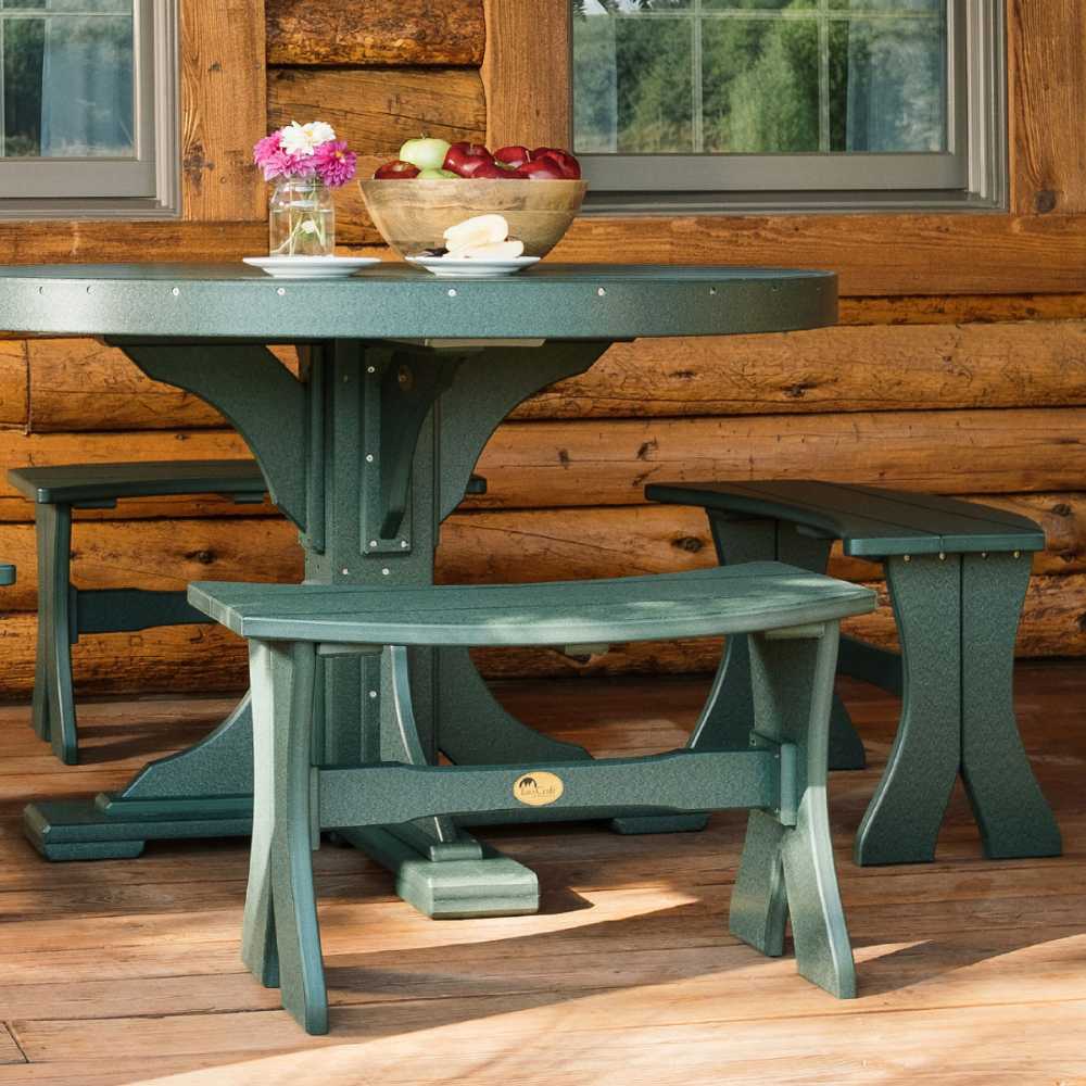 This image shows an outdoor furniture with a green LuxCraft 28 Table Bench in front of a log cabin paired with a matching round table