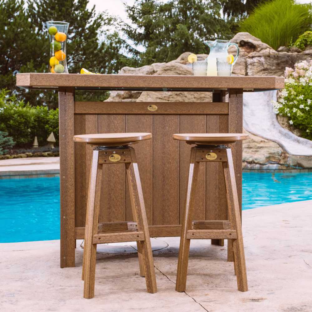 This image shows two ancient mahogany LuxCraft Bar Stools placed in front of a matching outdoor bar beside a pool