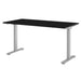 Three-quarter view of Crate & Barrel Humanscale® eFloat Go 2.0 60" Black Adjustable Standing Charging Desk with a sleek black surface and sturdy silver legs