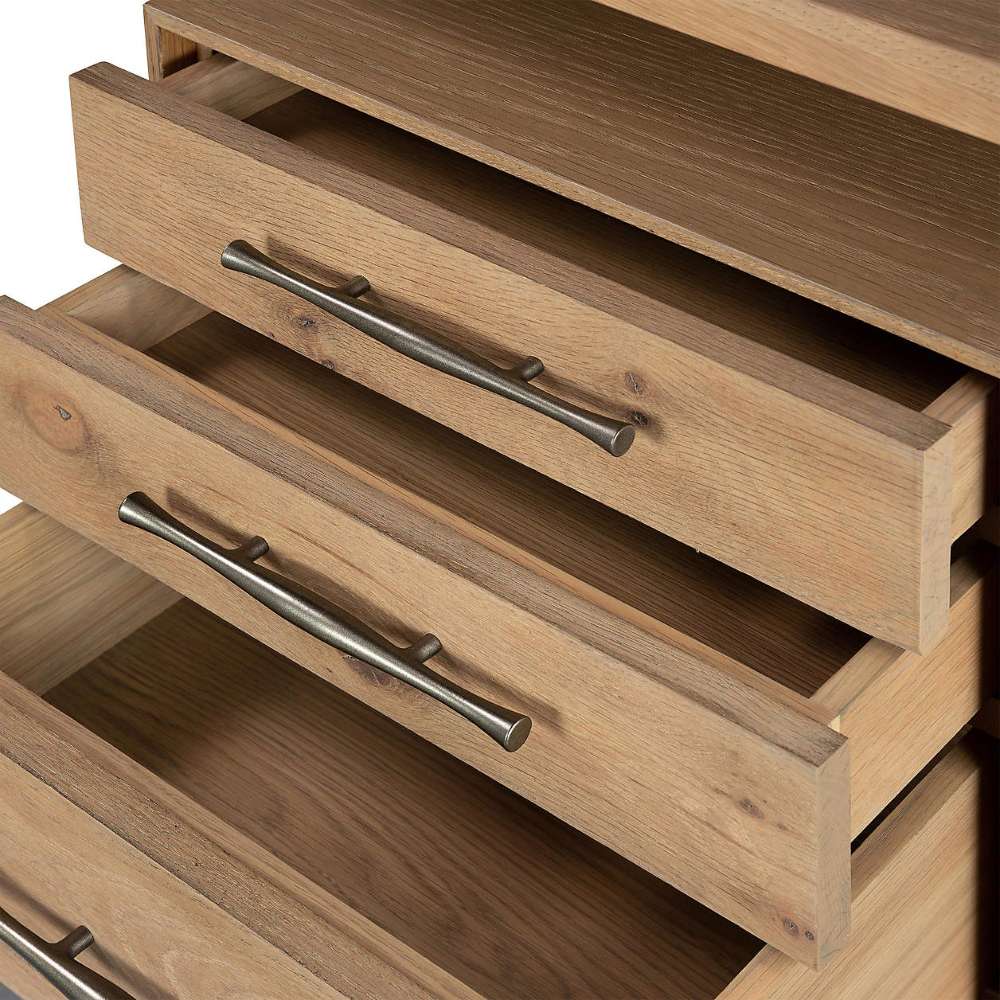 Three storage drawers are partially open on Crate & Barrel Sedgwick Solid Oak Wood Desk with Storage, revealing spacious interiors