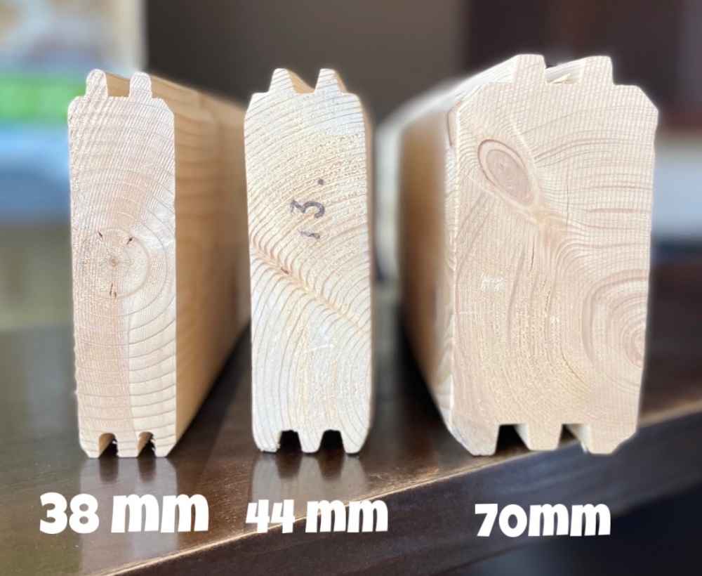 Three wooden log wall samples labeled 38mm, 44mm, and 70mm demonstrate the wall thickness option used in the Sawmill Structures The Versa 160 Atrium 70MM Garden Room