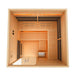 Top-down view into Golden Designs Toledo 6 Person Indoor Hybrid Sauna with Full Spectrum IR and Harvia Stove showing open floor space, a small bench and carbon heating panels along the walls