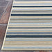 Top-down view of Couristan Dolce Indoor/Outdoor Rug - Striped/Nautical showcases its neat lines and rectangular shape on stone tiles.