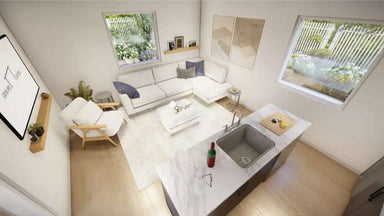 Top-down view of Sawmill Structures The Jasper Garden Suites shows a stylish open-concept living space with a marble island, couch, armchair, and large windows