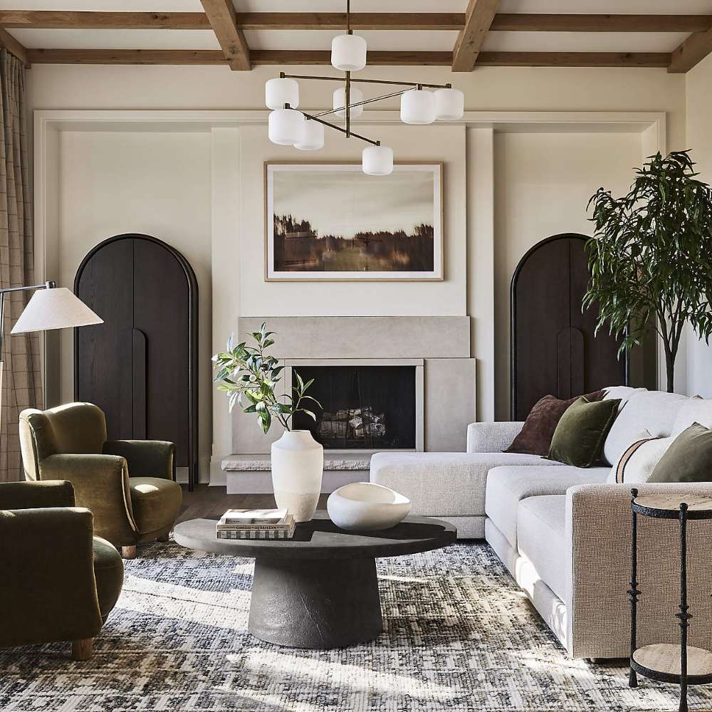 Two Crate & Barrel Annie 38" Charcoal Brown Storage Cabinet units flank a fireplace in a bright, modern living room