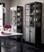 Two Crate & Barrel Casement 32" Black Storage Cabinet units display dishes, glassware, and serving pieces in a modern dining room