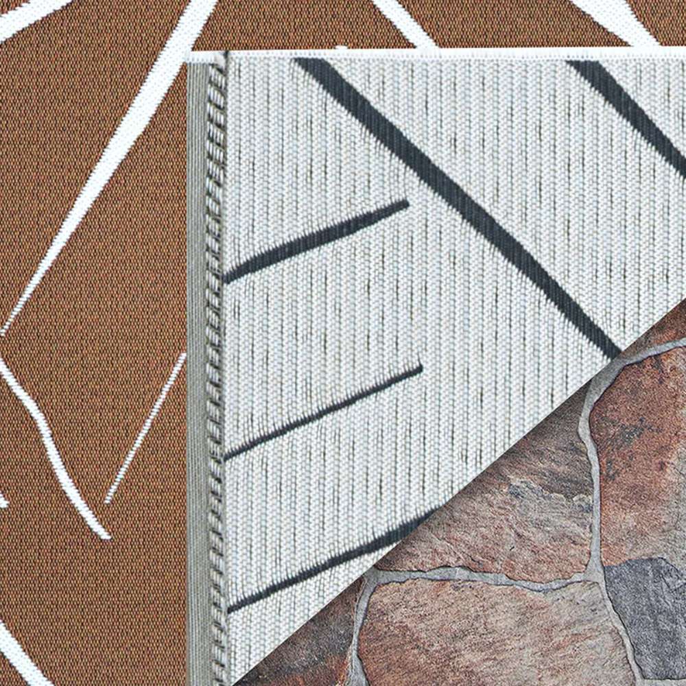 Underside of Couristan Dolce Indoor/Outdoor Rug - Parquet/Amber is flipped to show its durable ivory backing with dark gray pattern outlines