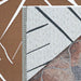 Underside of Couristan Dolce Indoor/Outdoor Rug - Parquet/Amber is flipped to show its durable ivory backing with dark gray pattern outlines