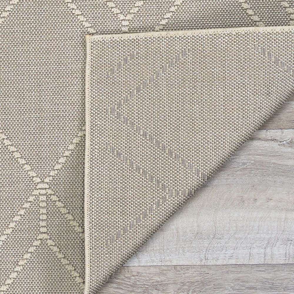 Underside of Couristan Liguria Indoor/Outdoor Rug - Noli/Dove Grey is revealed by a folded corner, showing its durable weave and texture