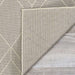Underside of Couristan Liguria Indoor/Outdoor Rug - Noli/Dove Grey is revealed by a folded corner, showing its durable weave and texture
