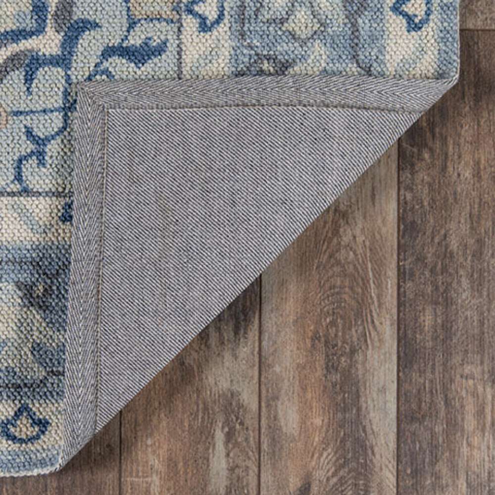 Underside of Momeni Anatolia Indoor Rug - ANA-9 Blue reveals a sturdy backing that helps keep it in place on hardwood floors