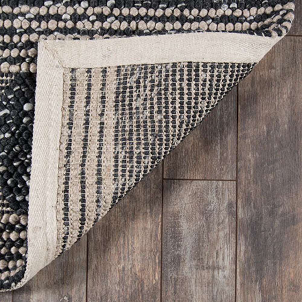 Underside of Momeni Andes Indoor Rug - AND-1 Charcoal reveals its tightly woven backing