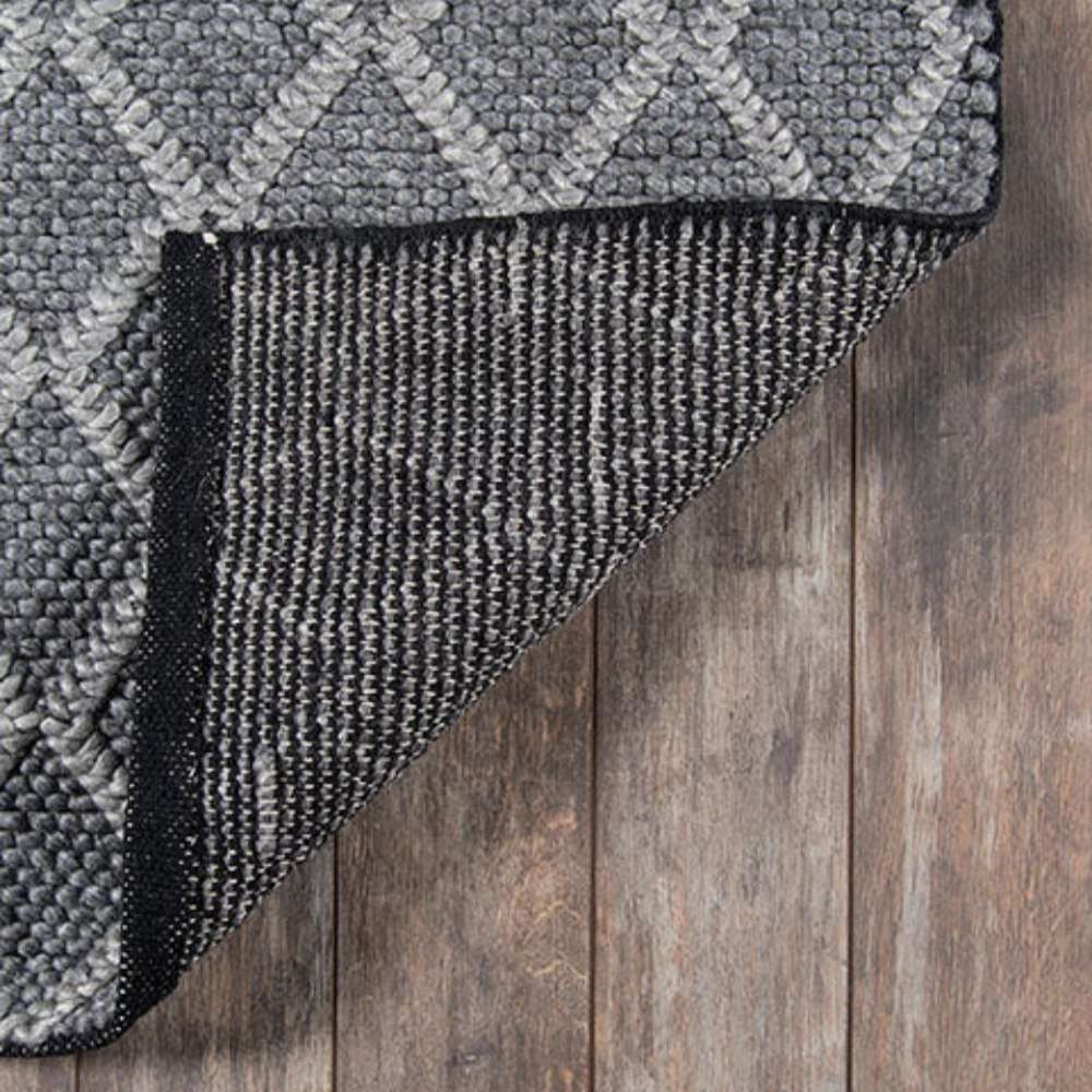 Underside of Momeni Andes Indoor Rug - AND-7 Charcoal reveals its sturdy backing