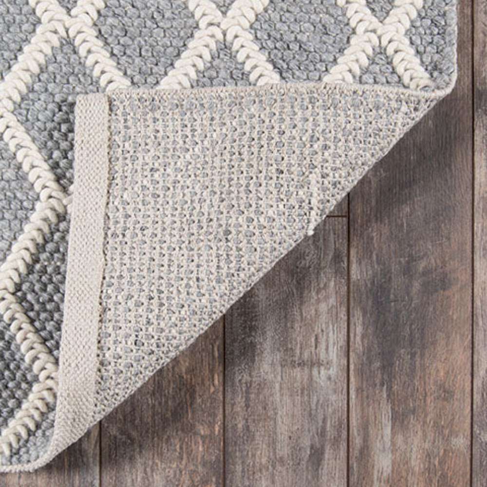 Underside of Momeni Andes Indoor Rug - AND-7 Grey reveals a sturdy backing that keeps the rug in place on hardwood floors