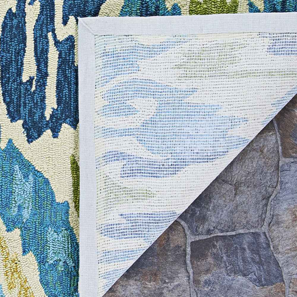 Underside of the Couristan Covington Indoor/Outdoor Rug - Delfina/Azure-Lemon is shown folded back