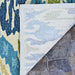 Underside of the Couristan Covington Indoor/Outdoor Rug - Delfina/Azure-Lemon is shown folded back