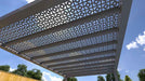 Up close, the angled slats and recessed lighting of a Structureworks Shadow Trex Pergola form a modern, dynamic canopy against the sky
