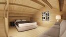 Upper loft of Sawmill Structures The Northwood Grand DD 70mm Garden Room includes a bed, a side table, and a couch beneath the wood-beamed ceiling