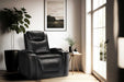 Valencia Oslo Nouvelle Home Theater Seating is shown as a sleek black recliner in a cozy, sunlit room