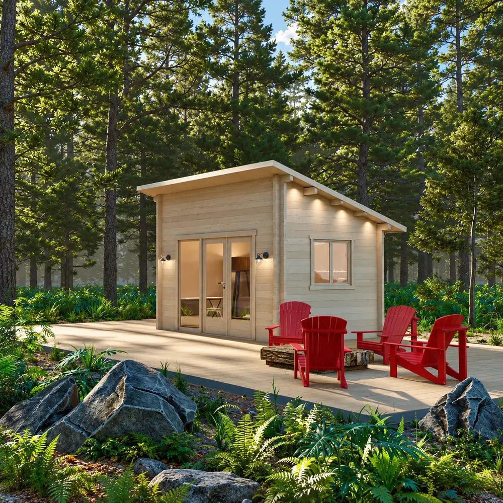 Warmly lit Versa 107 70MM cabin in a forest clearing with red Adirondack chairs, a log firepit, large boulders, ferns, and a wooden deck.