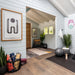 Serene Versa 240 70MM wellness interior with yoga mats and blocks, an exercise ball, plants, abstract wall art, a patterned rug, and a woven chair.
