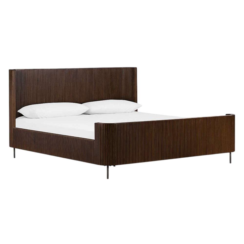 Viewed from an angle, Crate & Barrel Baylor Brown Ribbed Solid Oak Wood King Bed showcases a tall ribbed headboard, matching footboard, and slim metal legs