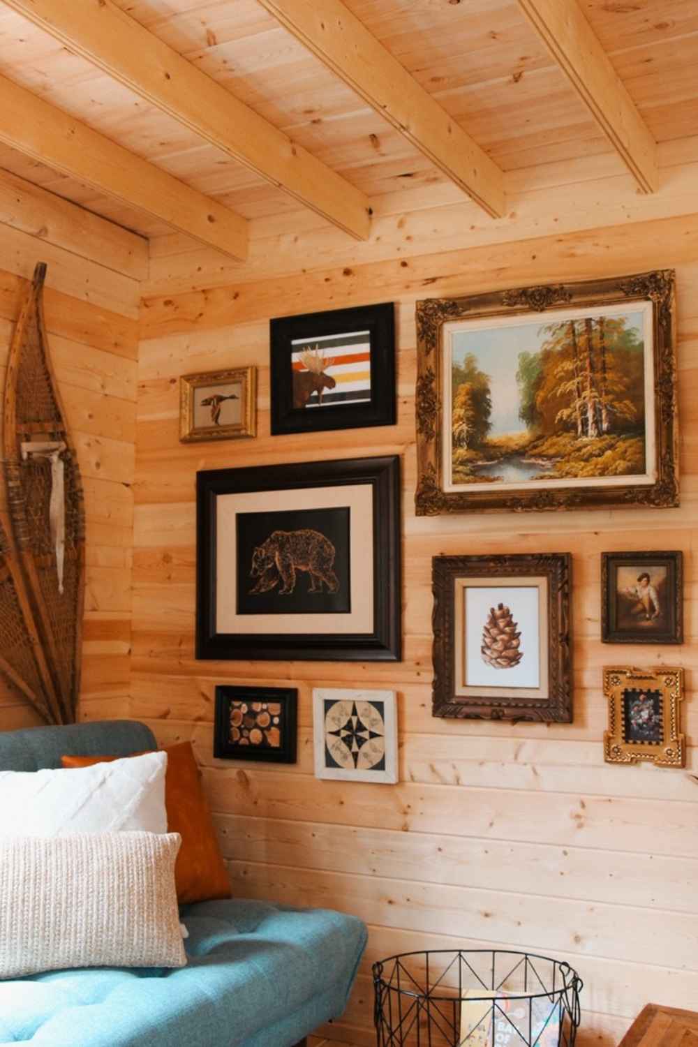 Wall filled with framed artwork and rustic decor adds charm to the lounge corner of the Sawmill Structures BlueWater Loft 160 38mm Garden Room