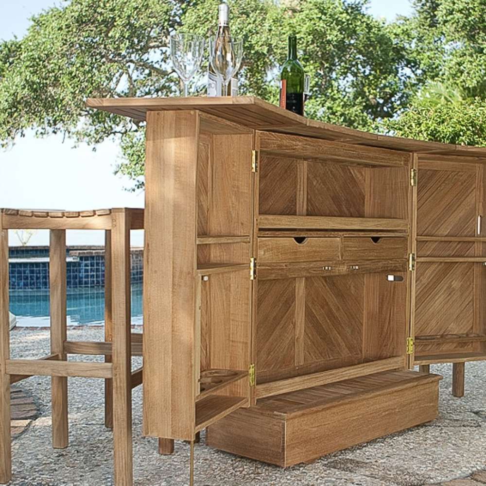 Westminster Teak 5pc Somerset Teak Bar & Stool Set shown outdoors near a pool with the bar open, holding wine bottles and glasses on top