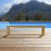 Westminster Teak 6ft Horizon Teak Backless Bench sits on a wooden deck overlooking a calm blue lake with green hills and trees in the distance