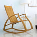 Westminster Teak Aria Rocker sits on a glossy floor beside a small white table and lamp