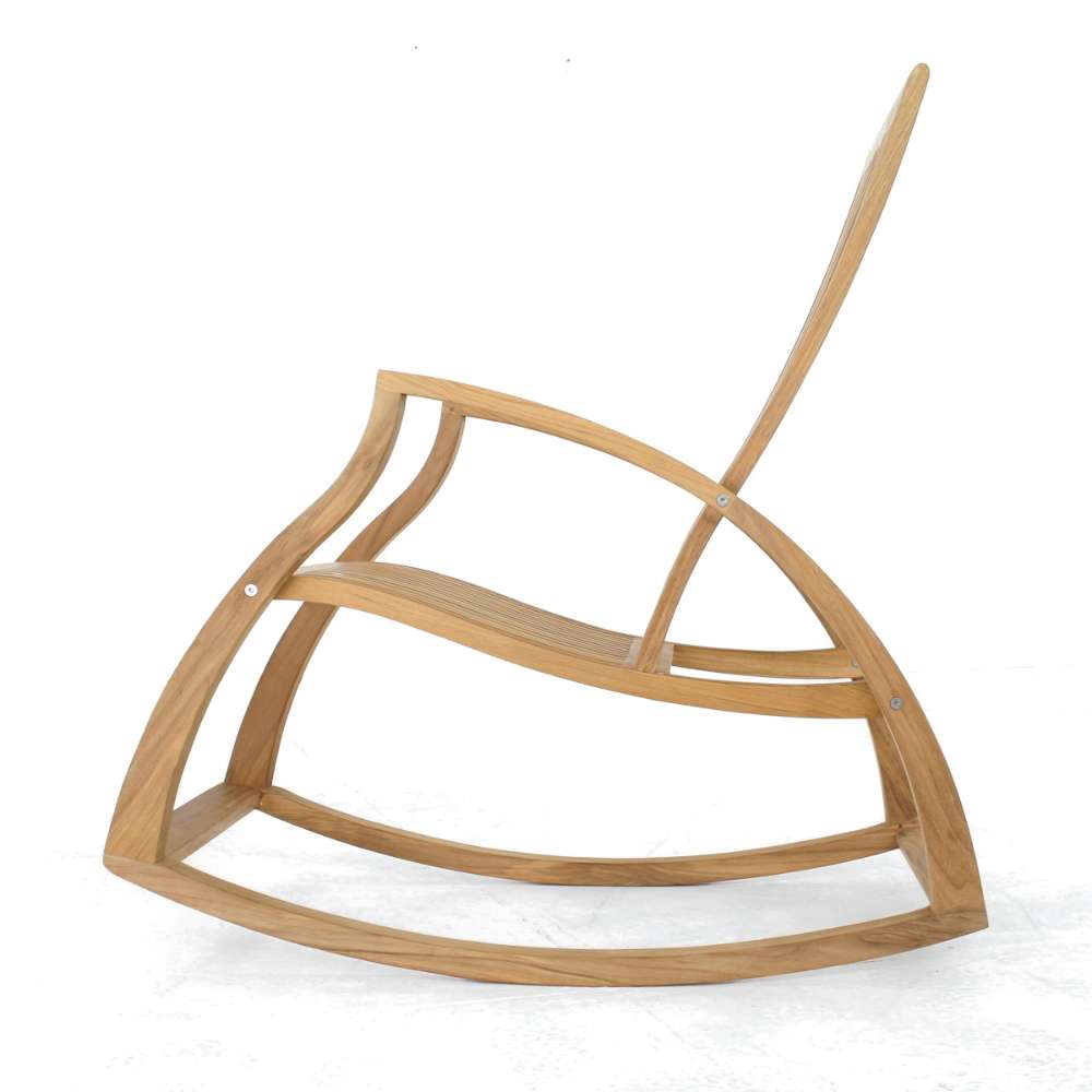 Westminster Teak Aria Teak Rocker is shown from the side, highlighting its curved rocking base, angled backrest, and ergonomic wooden slats