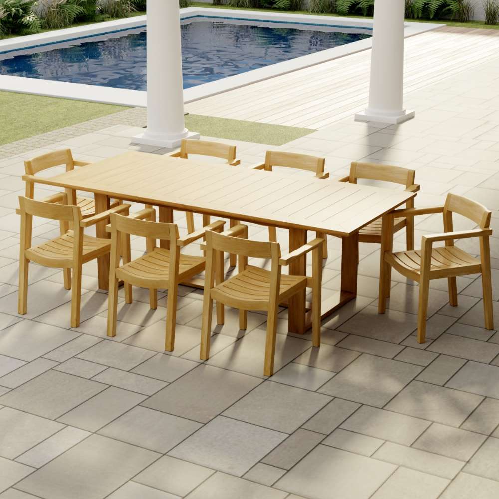Westminster Teak Horizon 9pcs Teak Dining Set arranged on a patio by a pool, with one large teak table surrounded by eight matching armchairs