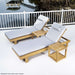 Westminster Teak Horizon Double Chaise and Side Table Set shown on a deck by calm water with two gray-cushioned loungers and small teak tables beside a white railing