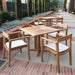 Westminster Teak Horizon Teak Dining Armchair appears in a patio dining set with cushions, arranged around a square table in an outdoor courtyard