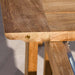 Westminster Teak Horizon Teak Dining Picnic Set close-up showing the smooth teak wood grain and rounded table edge detail