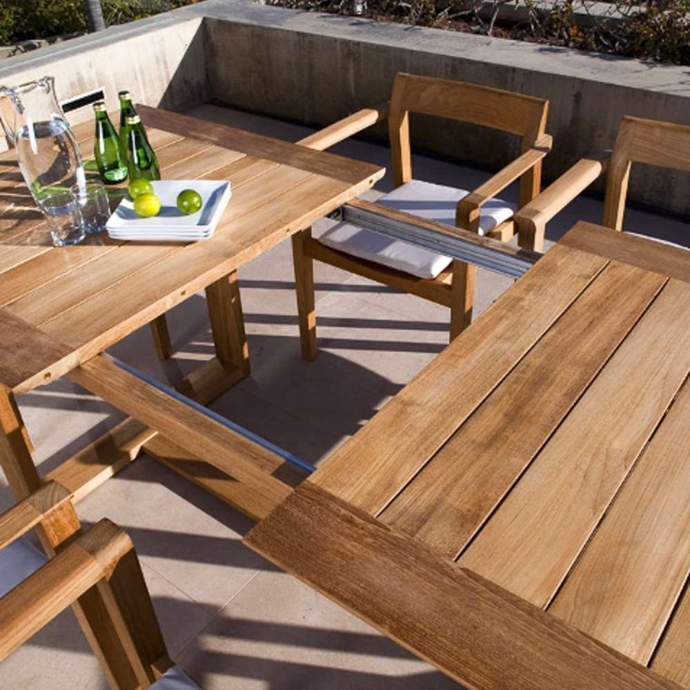 Westminster Teak Horizon Teak Dining Picnic Set on a patio with drinks and an extendable table leaf for flexible outdoor dining