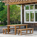 Westminster Teak Horizon Teak Dining Picnic Set under a pergola on a terrace surrounded by lush outdoor plants