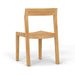 Westminster Teak Horizon Teak Side Chair is viewed from a slight angle, highlighting its gently curved seat and sturdy rectangular frame made of light-colored teak wood