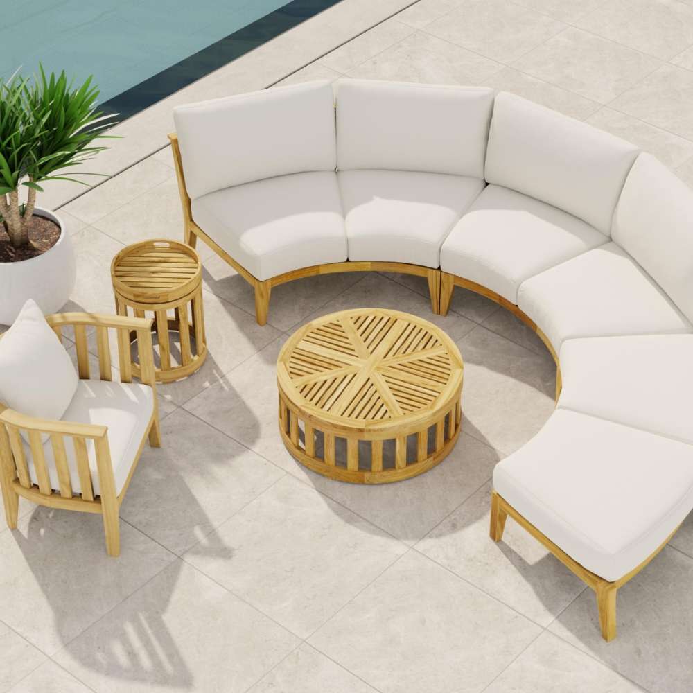 Westminster Teak Kafelonia 6pc Sofa Sectional Set on a poolside patio with white cushions and a round teak table