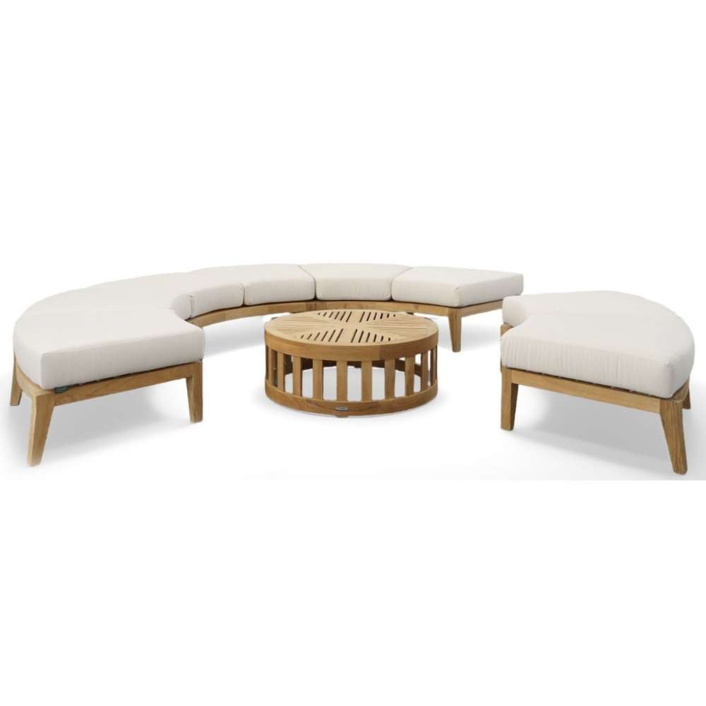 Westminster Teak Kafelonia Backless Sofa Sectional surrounds a round teak coffee table with soft cushions for a complete patio set
