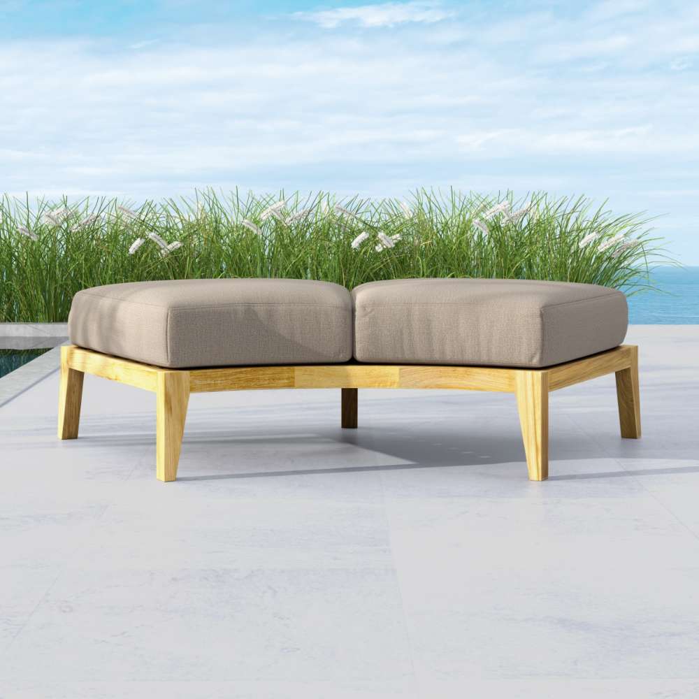Westminster Teak Kafelonia Backless Sofa Sectional with light cushions complements a patio with greenery and ocean views
