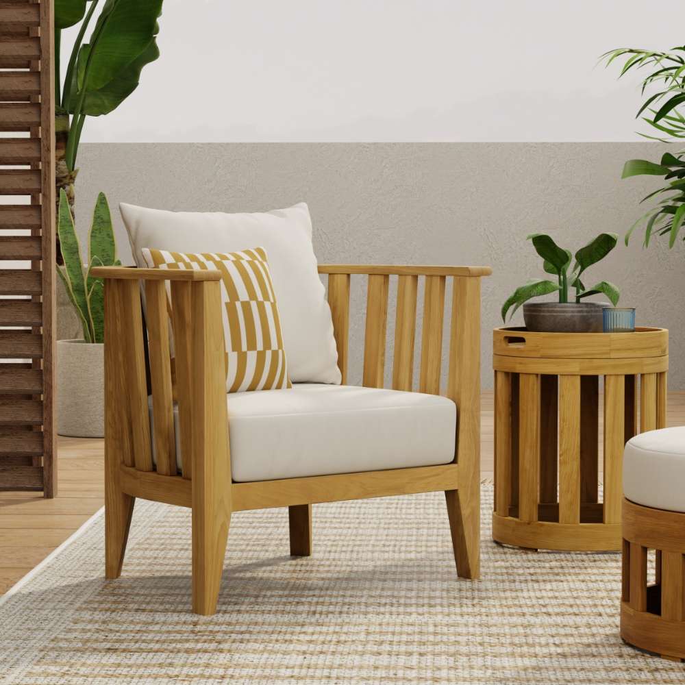 Westminster Teak Kafelonia Club Chair in a styled outdoor setting with white cushions, accent pillows, and a matching teak side table